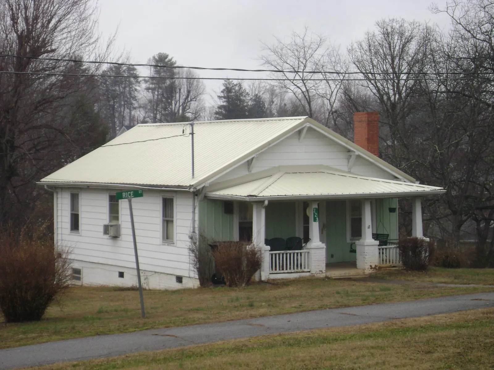 White metal roof on a craftsman bungalow at a street corner in Dewar